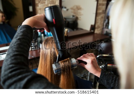 Making hairstyle using hair dryer.