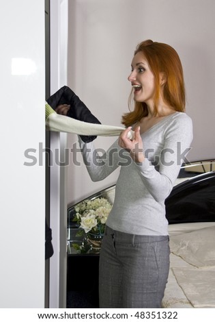 Surprised woman near the closet choosing what to wear