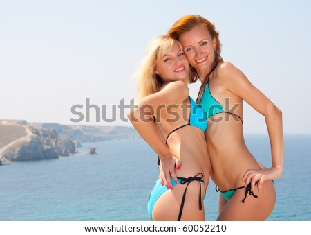 Two hot young women in bikini on the beach