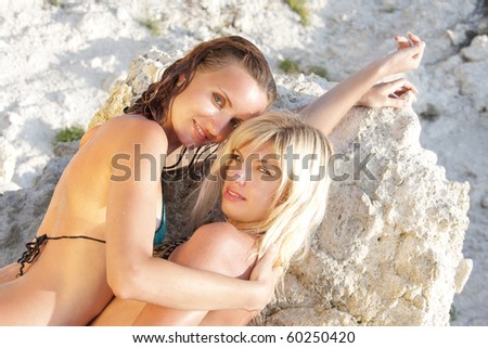 Two hot young women in bikini on the beach