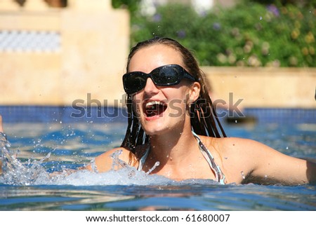 Happy swimming woman in pool