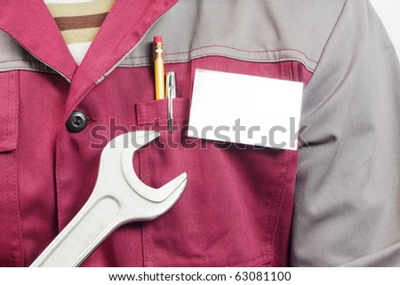 Close-up of blank name tag on service man uniform and big wrench