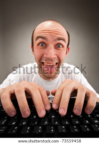 Portrait of funny nerd working on computer