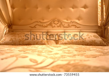 Interior of luxury vintage bedroom. Toned in gold