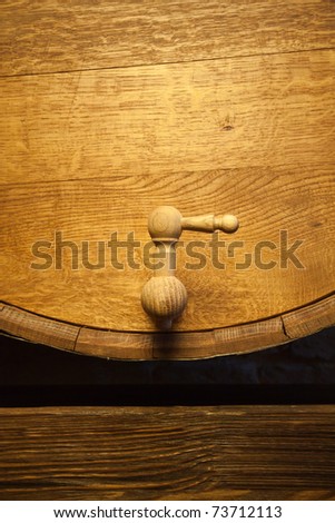 Big wood barrel with faucet in old wines cellar