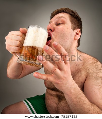 Portrait of funny fat man drinking beer