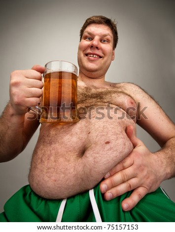 Portrait of funny fat man with glass of beer