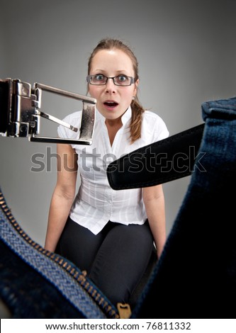 Surprised young girl looking inside unzipped man\'s pants