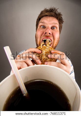 Portrait of expressive fat man eating fast food