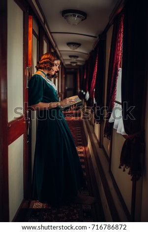 Young woman travels, vintage train compartment