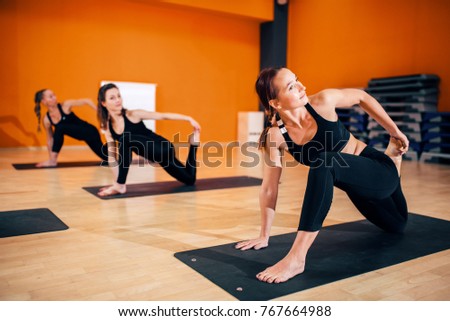 Female yoga group, training with instructor
