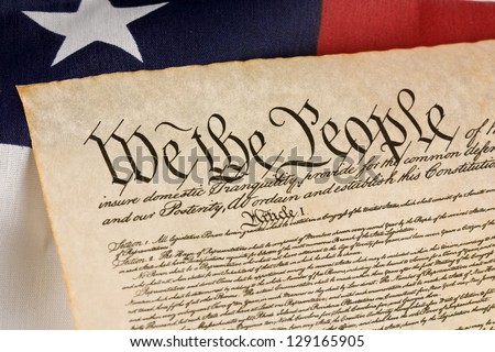 US Constitution against an american flag.