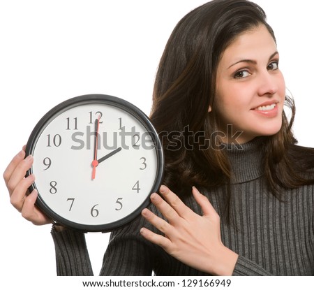 Woman setting clock at daylight savings time.