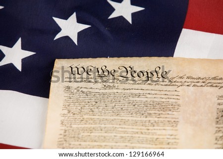 Declaration of Independence against an American flag.