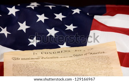 Declaration of Independence against an American flag.