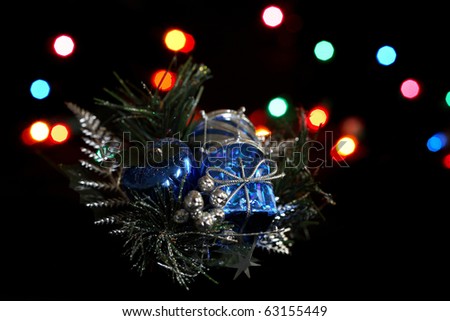 A holiday decoration in front of holiday colored lights