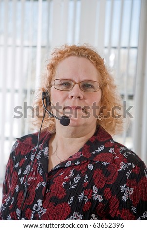 Productive middle aged woman working in a call center