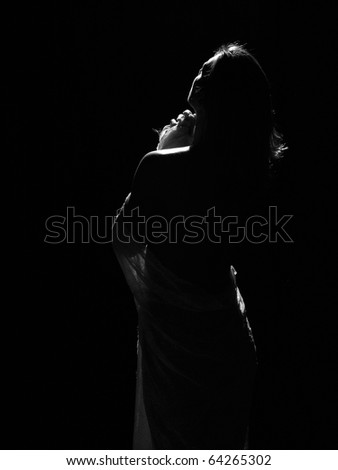 Woman in body style studio shot looking towards the light