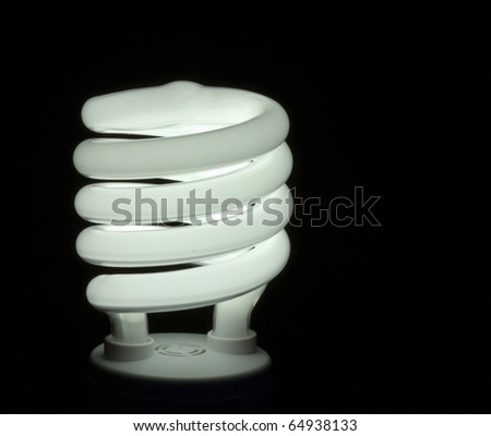 Energy efficient fluorescent light bulb on black background