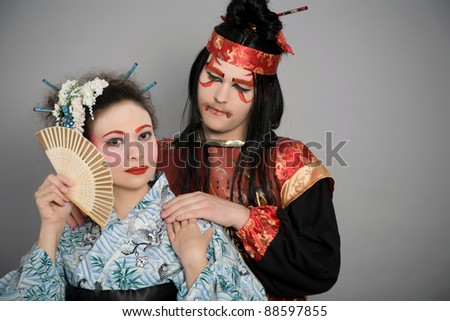 Two japanese lovers in historic clothing and stage makeup.