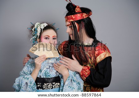 Two japanese lovers in historic clothing and stage makeup.