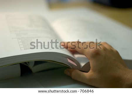 open book with hand, soft focus