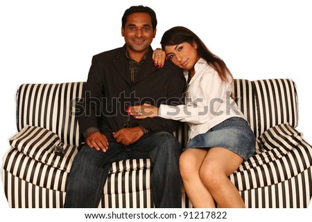 Arab romantic couple watching TV together at a house