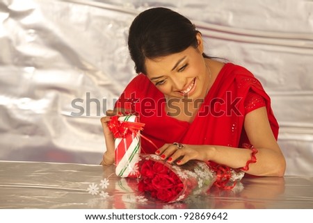 Business woman with gift box and flowers . Isolated