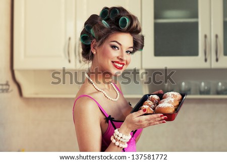 Young attractive girl in beautiful clothes bakes cakes. Pin-up style images. grain added