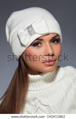 Young attractive girl in warm winter clothes. Studio shot