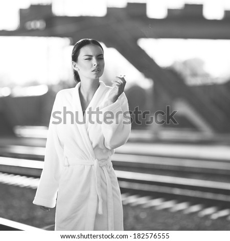 Black and white shoot of woman on train station;