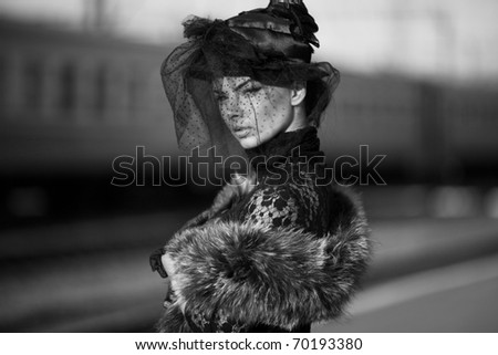 Black and white shoot of woman on train station;