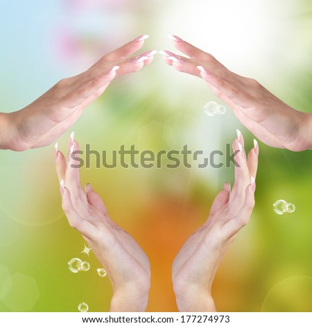 Abstract House of female hands on blue green summer nature background.Happiness Concept