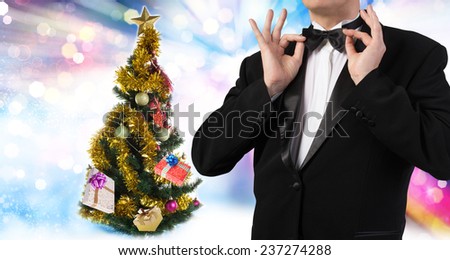 Men in tuxedo and Christmas eve tree with Gifts