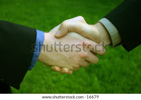 Handshake with the grass as a background