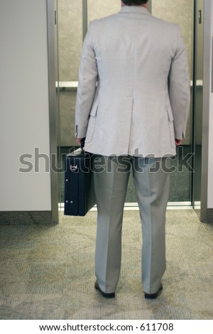 businessman faces open elevator
