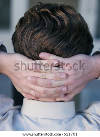 businessman with hands behind head