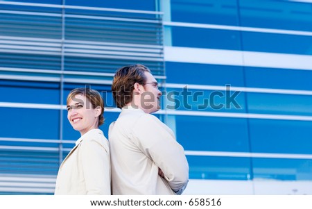 Businessman and woman back to back