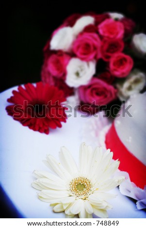 white wedding cake with pink trim and white and pink flowers