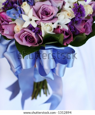 bridal bouquet of blue and purple flowers with a blue ribbon