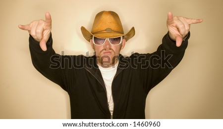 Cowboy wearing a cowboy hat with his hands in the air in the shape of a longhorn