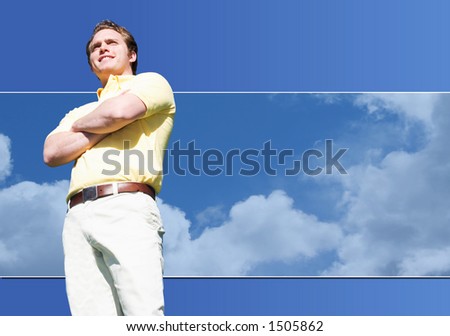 Happy Man stands in front of a blue sky and clouds while wearing a yellow shirt