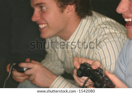 Two young men are playing video games side by side