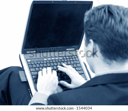 black and white shot of businessman typing on his laptop