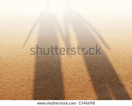 stock photo : Abstract picture of shadow of couple holding hands with sandy 
