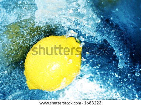 Yellow lemon in rushing, clear, blue water