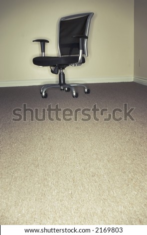 Single black and gray office chair is alone in the office room in the corner of the office