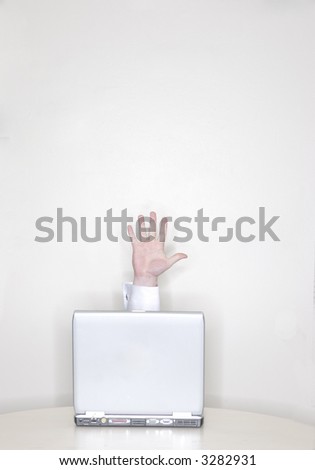 Hand coming out of a laptop with the hand open in front of a white background