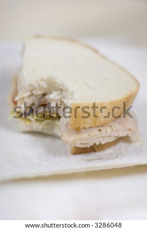 Turky Sandwhich on Sourdough bread on the table with a bite in it
