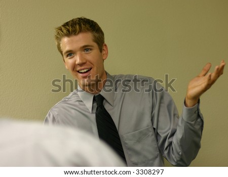 Businessman looks at another person with his hands in the air in a surprise